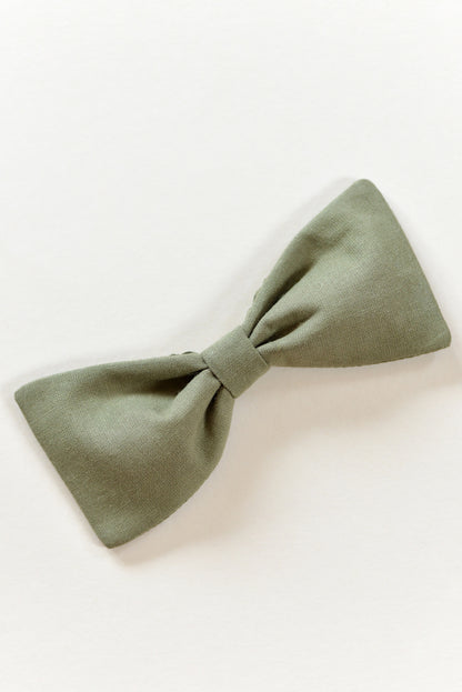 Handmade khaki green bow on a light background.