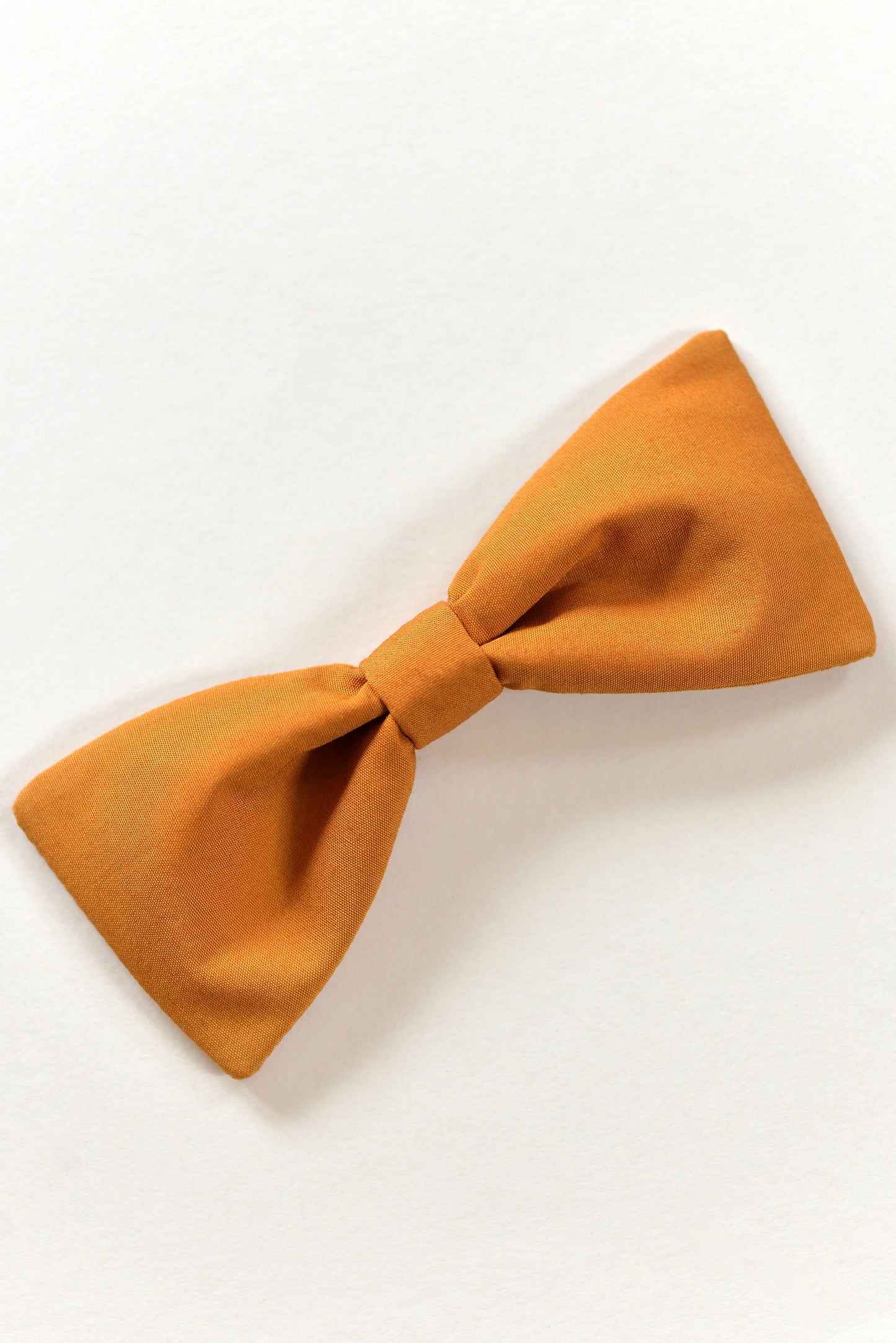 Handmade ochre bow on a light background.