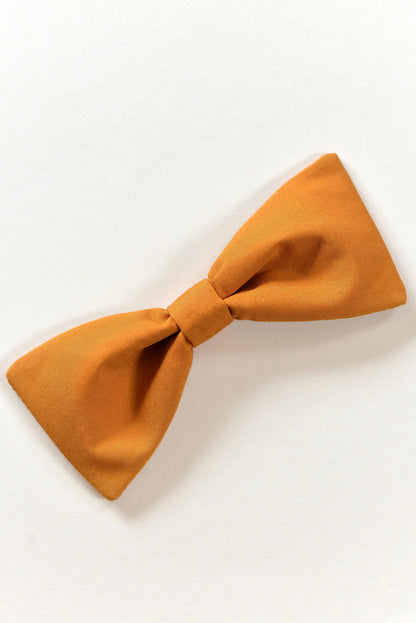 Handmade ochre bow on a light background.