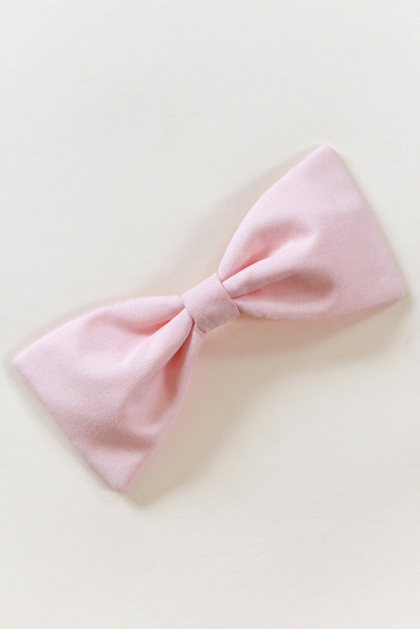 Handmade rosy pink bow on a light background.
