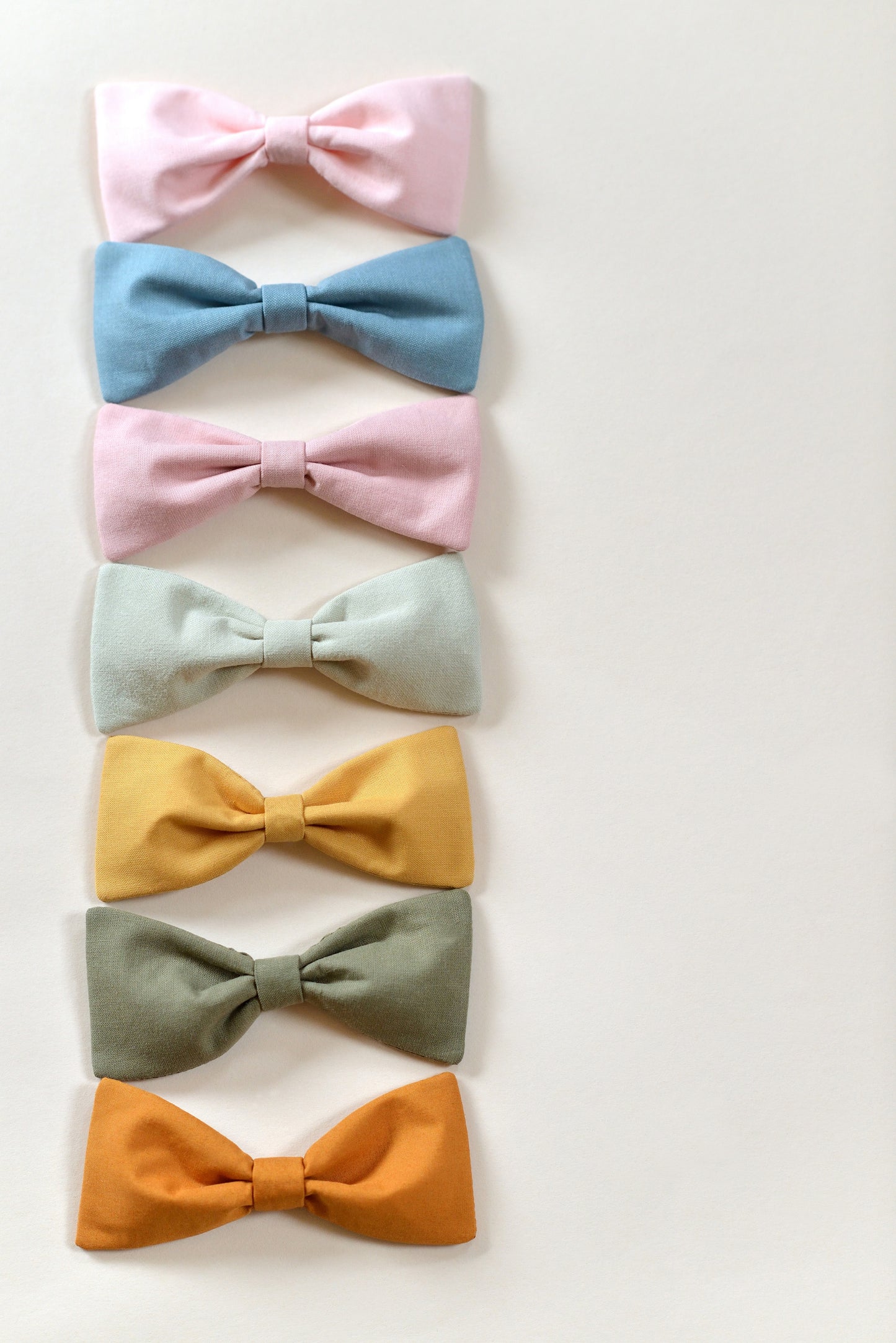 Set of colorful bows arranged in a row on a light background