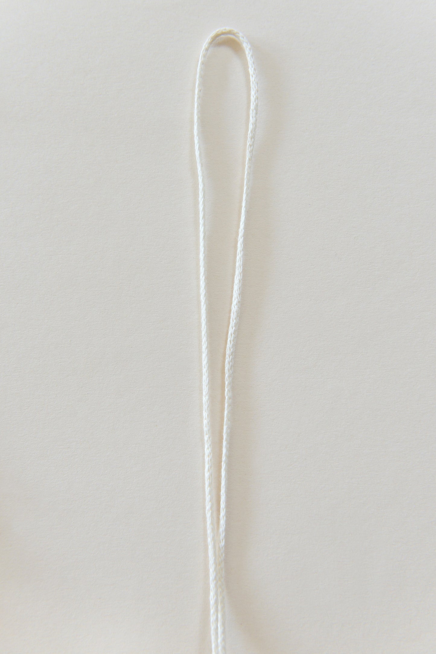 White marcrame rope against a light backround.