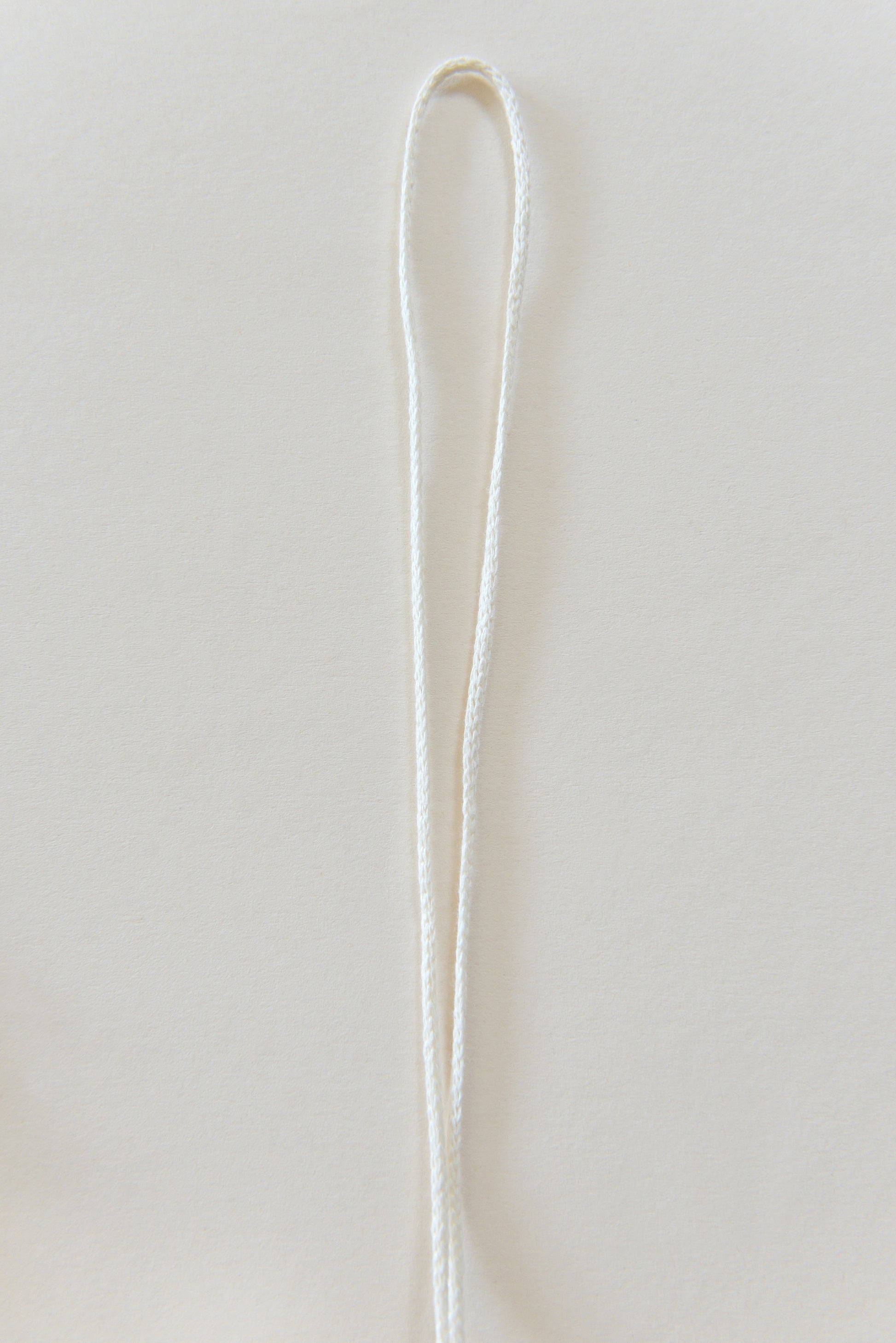 White marcrame rope against a light backround.