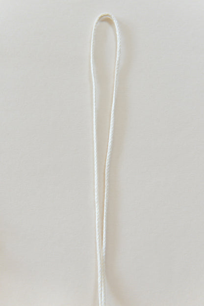 White marcrame rope against a light backround.