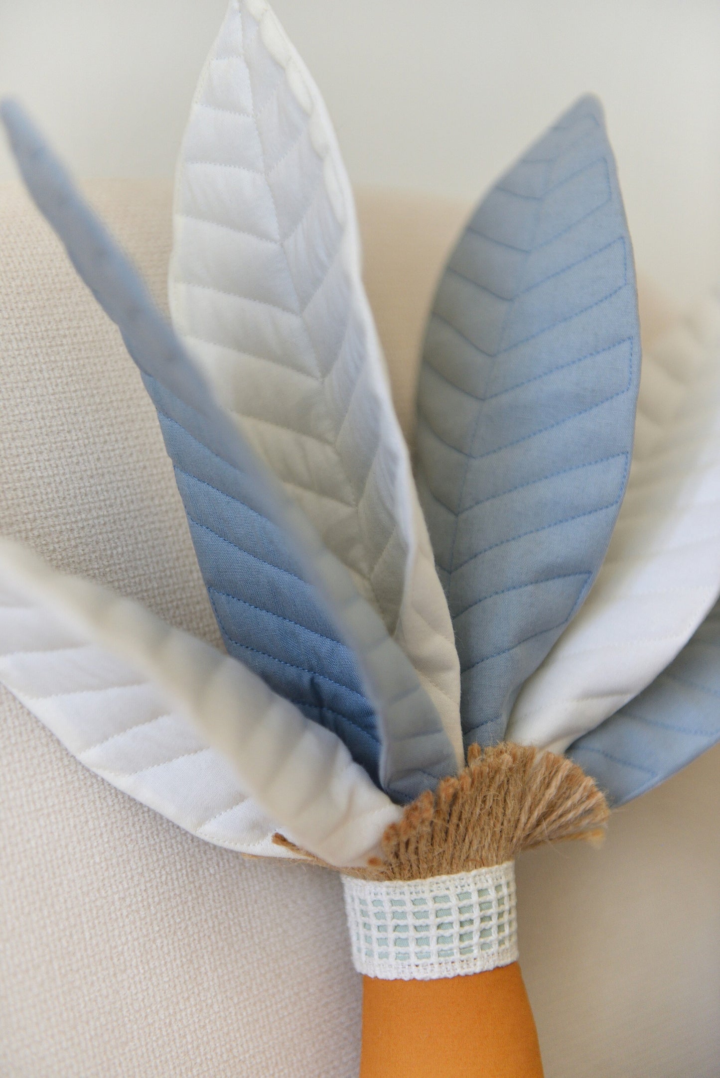 Steal Blue Palm Tree Decor Pillow up close handmade by Boho Baby Heaven. Featuring mixed offwhite and steal blue palm fronds and ochre trunk.